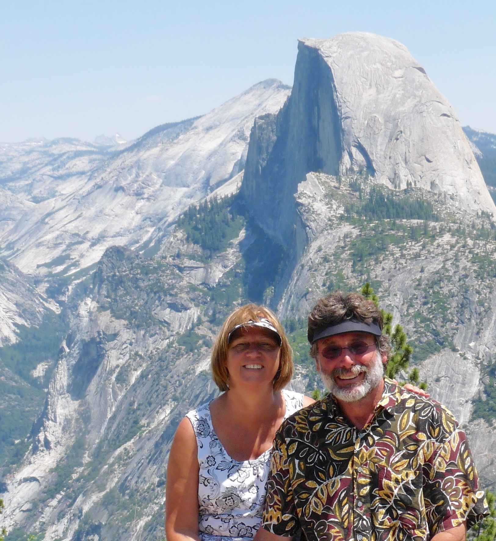 Carol & Rodney Baughman wearing visors in front of Half Dome in Yosemite